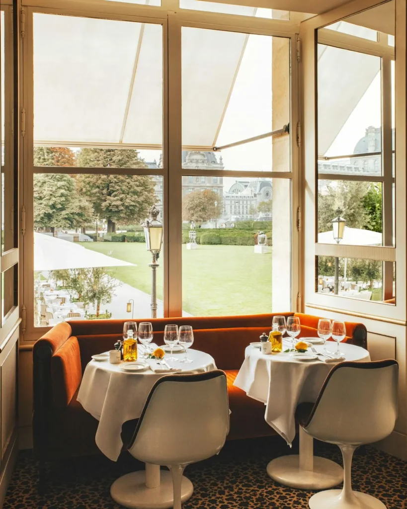 Bright dining room overlooking the gardens at Loulou Paris