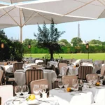 Outdoor dining tables overlooking the gardens at Loulou Paris