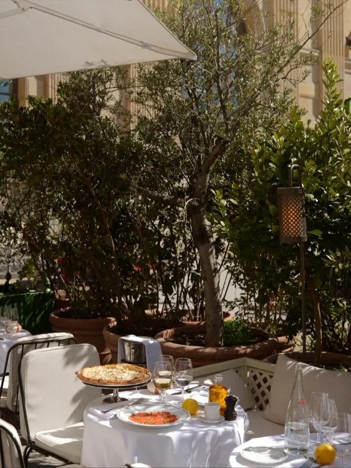 Outdoor dining terrace at Loulou Paris surrounded by greenery