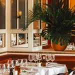 Elegant restaurant interior with greenery at Loulou Paris