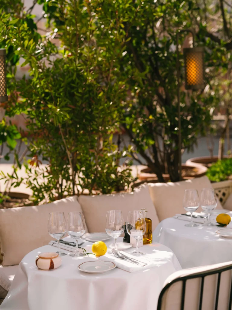 Outdoor dining table surrounded by greenery at Loulou Paris