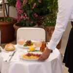 Outdoor dining area with white umbrellas at Loulou Paris
