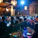 Guests enjoying dinner and entertainment at Maison Milano