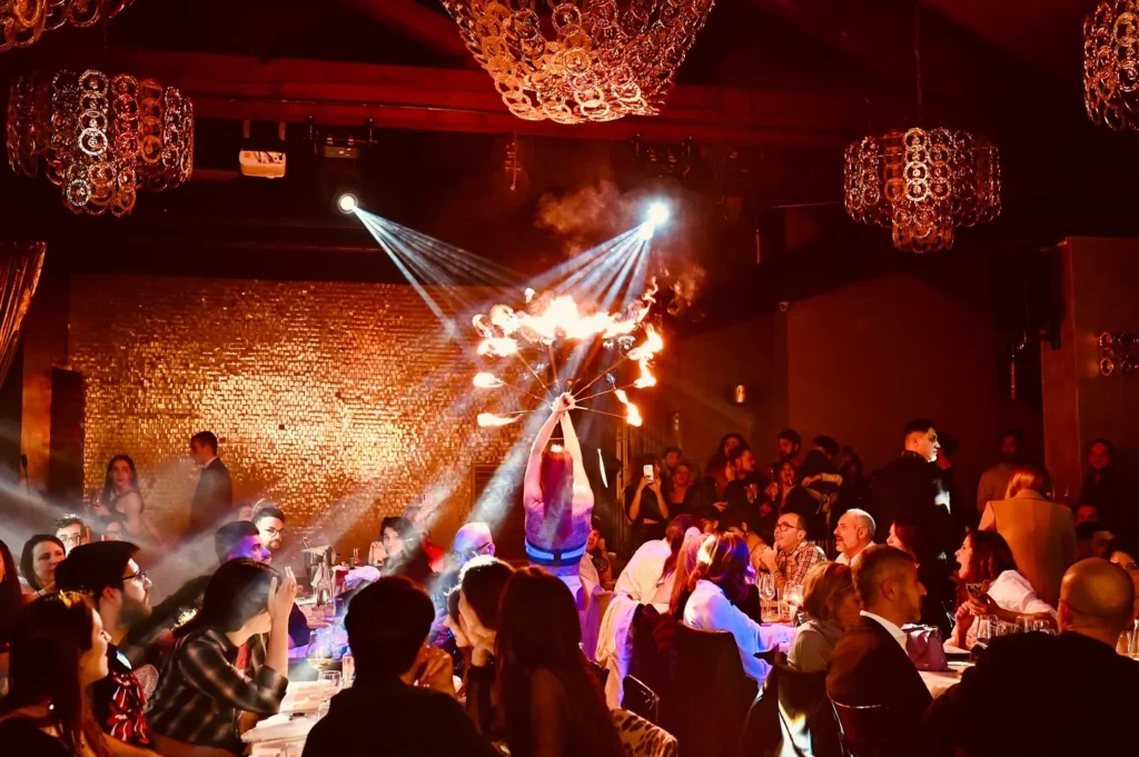 Guests watching a live dinner show at Maison Milano