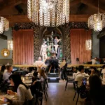 Guests watching a live performance during dinner at Maison Milano
