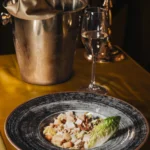 Gourmet dish presented on a plate at Maison Milano