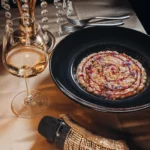 Pasta dish served with wine at Maison Milano