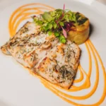 Plated seafood dish served at Maison Milano
