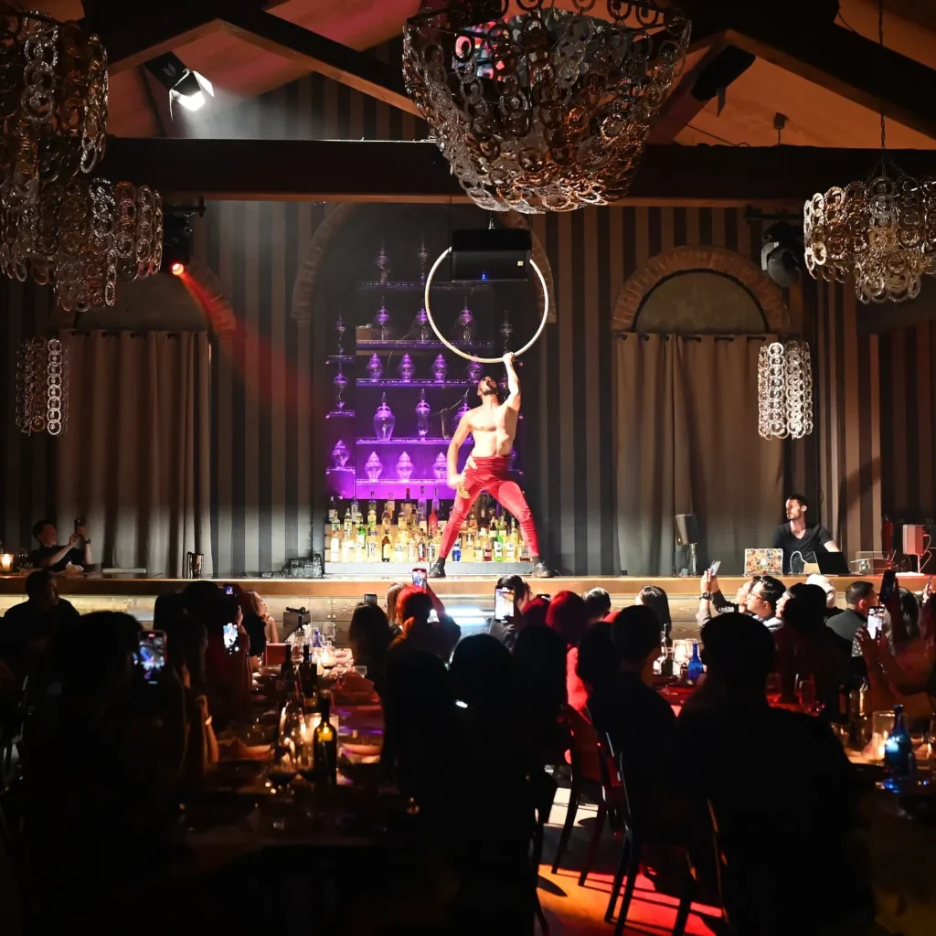 Performer on stage in front of guests at Maison Milano