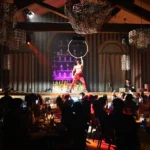 Performer on stage in front of guests at Maison Milano
