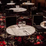 Elegant round tables arranged in the dining area at Matignon Paris