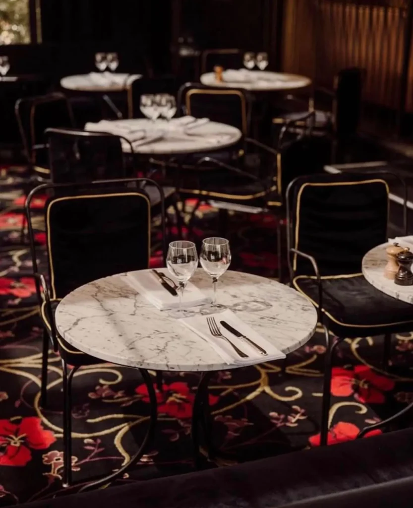 Elegant round tables arranged in the dining area at Matignon Paris