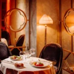 Warmly lit dining area with elegant table settings at Matignon Paris