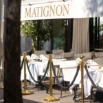 Elegant entrance to Matignon Paris with outdoor seating