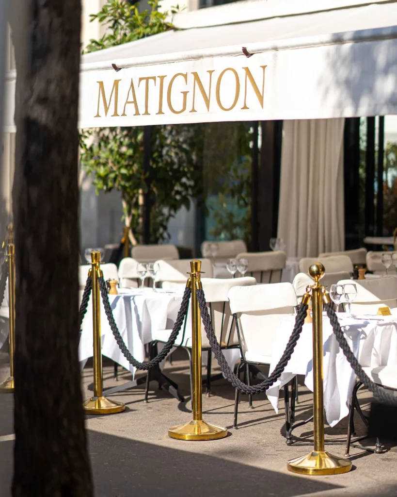 Elegant entrance to Matignon Paris with outdoor seating