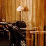 Intimate dining corner with warm wood paneling at Matignon Paris