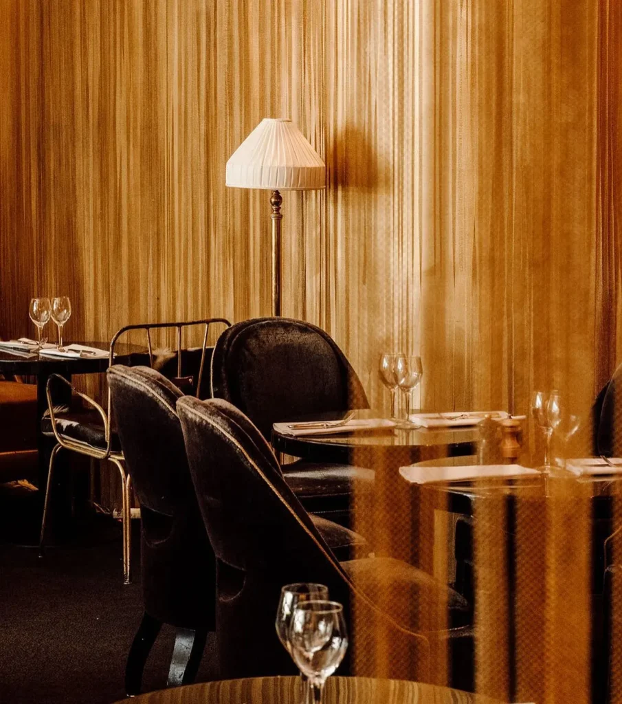 Intimate dining corner with warm wood paneling at Matignon Paris