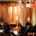 Warmly lit lounge with wood paneling at Matignon Paris