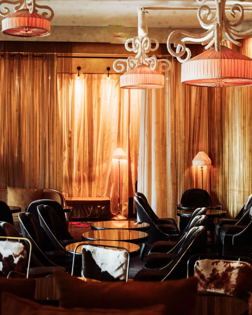 Warmly lit lounge with wood paneling at Matignon Paris