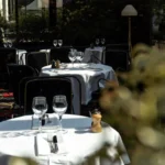 Outdoor dining tables surrounded by greenery at Matignon Paris