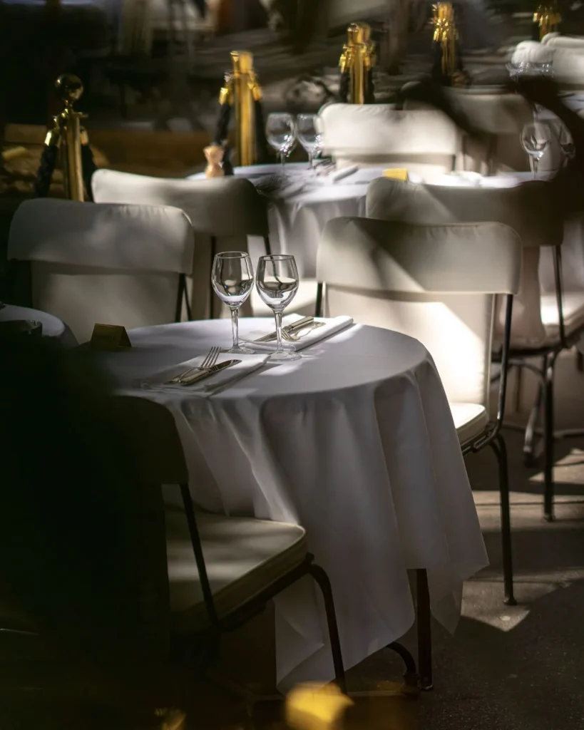 White tablecloth dining area outside Matignon Paris