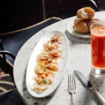 Seafood dish served with bread and a drink at Matignon Paris