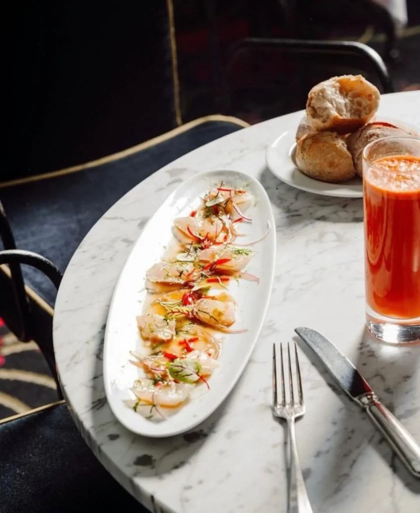 Seafood dish served with bread and a drink at Matignon Paris