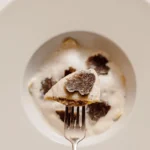 Fine dining dish topped with shaved truffle at Matignon Paris