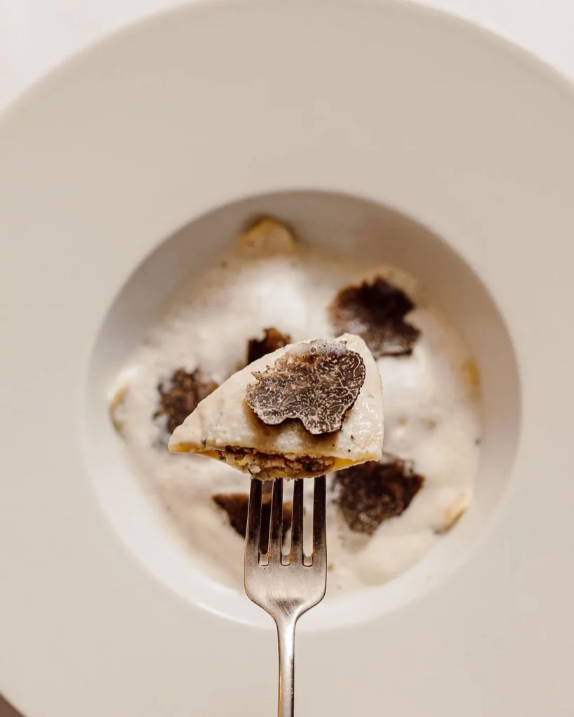 Fine dining dish topped with shaved truffle at Matignon Paris