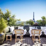 MUN Paris outdoor terrace with tables and a view of Paris