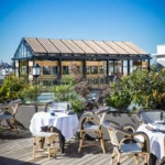 Outdoor terrace dining area at MUN Paris with Paris views