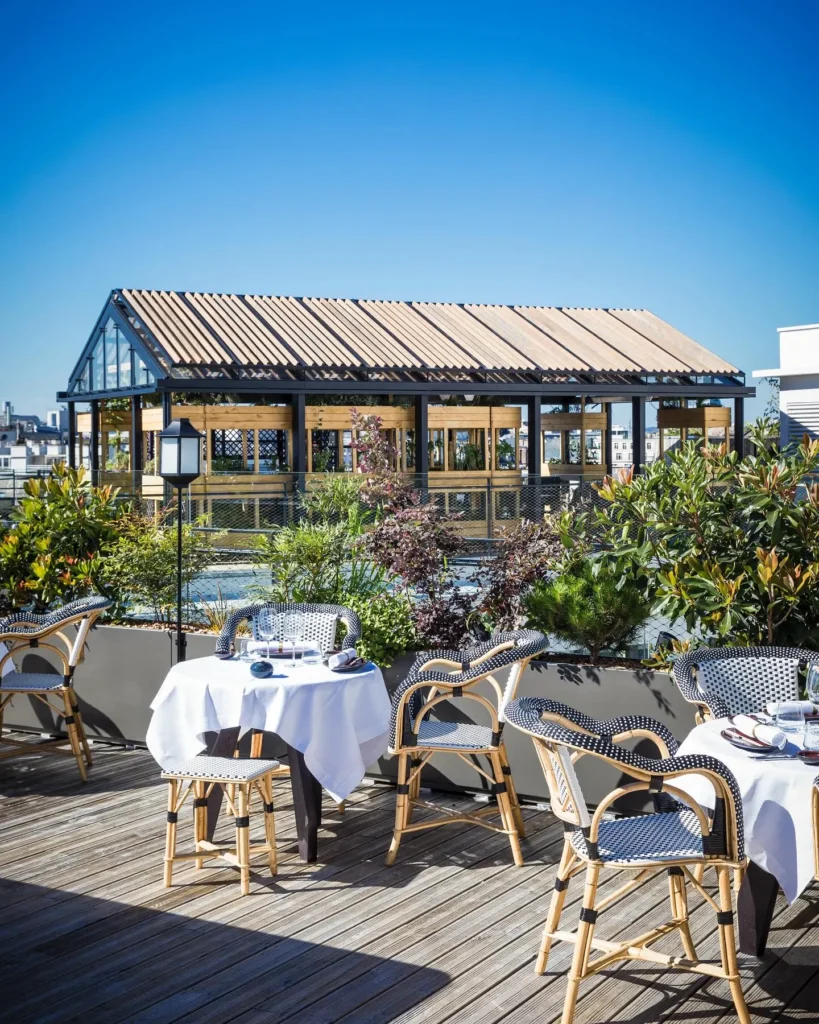 Outdoor terrace dining area at MUN Paris with Paris views