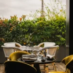 Outdoor terrace seating with umbrellas and plants at MUN Paris