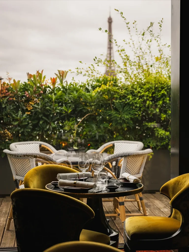 Outdoor terrace seating with umbrellas and plants at MUN Paris