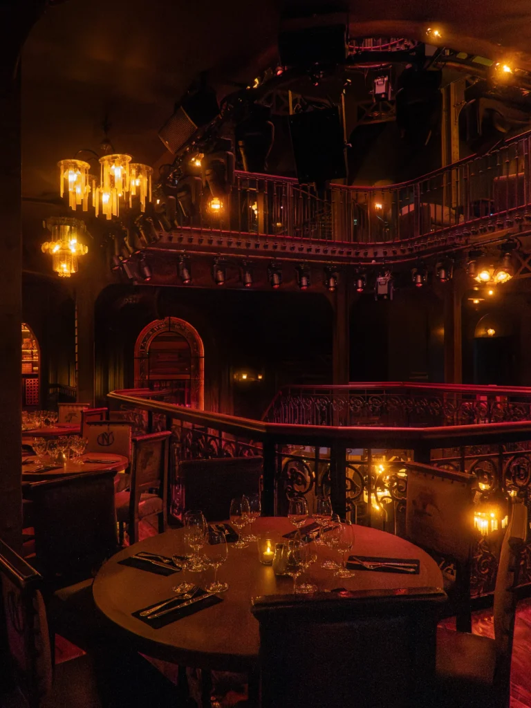 Multi-level dining room with warm lighting at Pachamama Paris