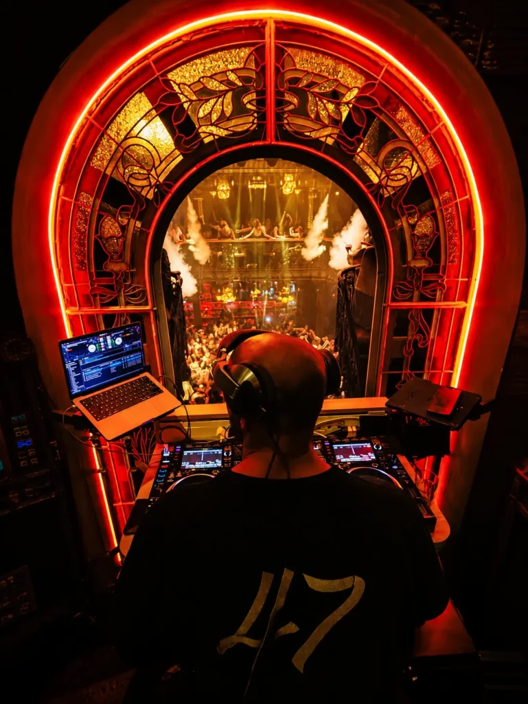 DJ booth beneath a glowing arch inside Pachamama Paris