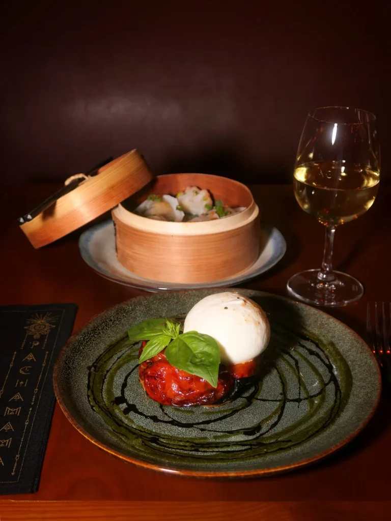 Gourmet plated dish served with wine at Pachamama Paris
