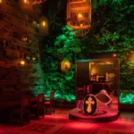 Colorfully lit lounge area with greenery inside Pachamama Paris