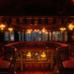 Illuminated stage and balcony inside Pachamama Paris