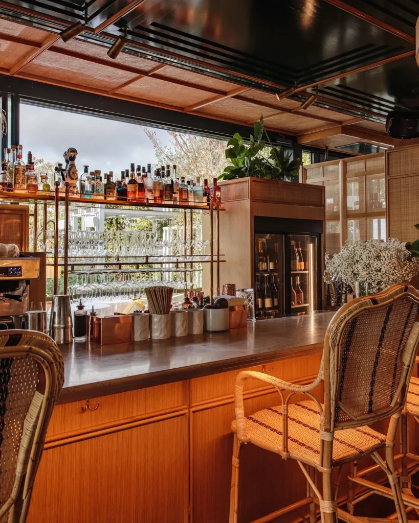 Warm wooden bar interior at Perruche Paris