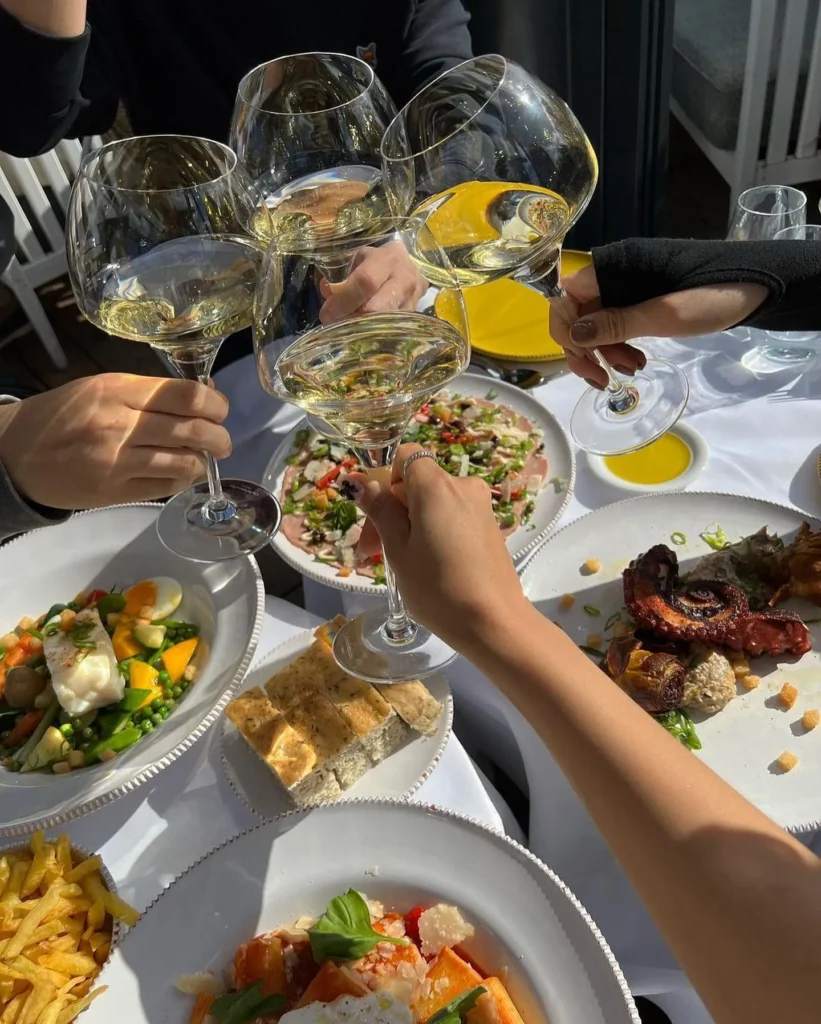 Guests enjoying food and drinks at Perruche Paris