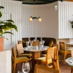Warm wooden bar interior at Perruche Paris