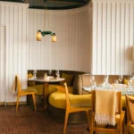 Elegant dining room with warm furnishings at Perruche Paris