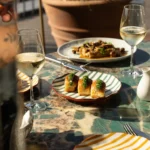 Food and wine arranged on a table at Perruche Paris