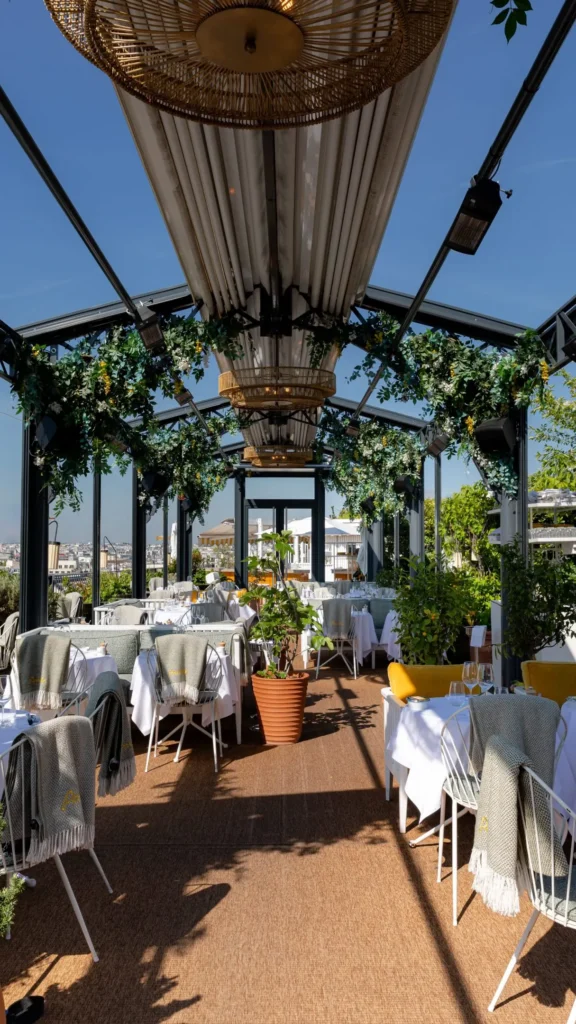 Outdoor dining tables on the rooftop terrace at Perruche Paris