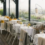 Rooftop dining area at Perruche Paris with views of Paris