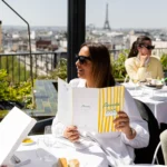 Outdoor terrace dining at Perruche Paris with the Eiffel Tower in the distance