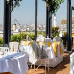 Elegant terrace dining area at Perruche Paris overlooking Paris