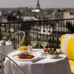 Outdoor table set for dining at Perruche Paris overlooking Paris