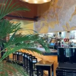 Decorative restaurant interior with greenery at Plaza Athenee in Paris